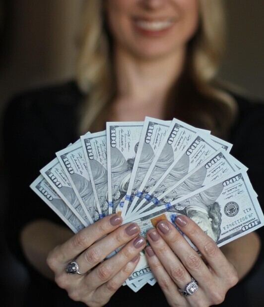 image of woman fanning money in her hands